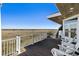 Outdoor deck with rocking chairs and stunning views of the marsh and waterway at 1136 Ocean Forest Ln, Seabrook Island, SC 29455
