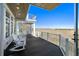 Outdoor deck with rocking chairs and views of the surrounding water at 1136 Ocean Forest Ln, Seabrook Island, SC 29455