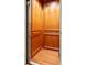 Interior view of an elevator with wood-paneled walls and flooring for easy accessibility at 1136 Ocean Forest Ln, Seabrook Island, SC 29455