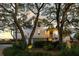 Beautiful coastal home with mature trees, manicured landscaping, and a charming front porch at 1136 Ocean Forest Ln, Seabrook Island, SC 29455