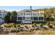 Expansive two-story coastal home with multiple balconies and screened-in porches overlooking the manicured dunes at 1136 Ocean Forest Ln, Seabrook Island, SC 29455