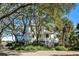 Charming home with mature trees providing shade and privacy, complemented by a welcoming entryway and staircase at 1136 Ocean Forest Ln, Seabrook Island, SC 29455