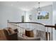 Bright hallway features curved railing, charming decor, and plenty of natural light from unique windows at 1136 Ocean Forest Ln, Seabrook Island, SC 29455