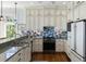 Modern kitchen featuring granite countertops, stainless steel appliances, and ample cabinet space at 1136 Ocean Forest Ln, Seabrook Island, SC 29455