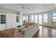 Bright living room with hardwood floors, custom built-ins, and views of the marsh from large windows at 1136 Ocean Forest Ln, Seabrook Island, SC 29455