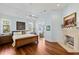 Bright main bedroom with wood floors, a fireplace, and a view to the water at 1136 Ocean Forest Ln, Seabrook Island, SC 29455