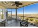A covered porch with a scenic view of a marsh with seating at 1136 Ocean Forest Ln, Seabrook Island, SC 29455
