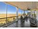 A covered porch with a scenic view of a marsh with comfortable seating at 1136 Ocean Forest Ln, Seabrook Island, SC 29455