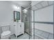 Well-lit bathroom showcasing a glass-enclosed shower, vanity, toilet, and storage rack, perfect for your convenience at 117 Swan Dr, Summerville, SC 29485