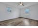 Bright, airy bedroom featuring modern ceiling fan, light paint, and hardwood floors; two windows letting in natural light at 117 Swan Dr, Summerville, SC 29485