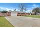 Spacious brick home with a long driveway leading to a garage, surrounded by a green lawn at 117 Swan Dr, Summerville, SC 29485