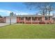 Charming red brick ranch-style home with a well-manicured lawn, black shutters, and a covered front porch at 117 Swan Dr, Summerville, SC 29485