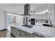 Modern kitchen boasts stainless steel appliances and a stylish island with a cooktop and unique brick accent at 117 Swan Dr, Summerville, SC 29485
