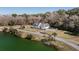 Stunning aerial perspective of lakeside home with sprawling lawns and tree lined perimeters on a sunny day at 1174 Hitchfield Ln, Awendaw, SC 29429