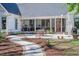 Landscaped backyard with a charming patio, walkway, and a view of the screened-in porch at 1174 Hitchfield Ln, Awendaw, SC 29429