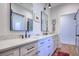 Bathroom featuring double vanities, marble countertop, modern fixtures, and framed mirrors above with wood look floors at 1174 Hitchfield Ln, Awendaw, SC 29429