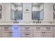 Bathroom with dual sinks, a white marble countertop, modern fixtures, and framed mirrors above each sink at 1174 Hitchfield Ln, Awendaw, SC 29429