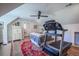 Bedroom featuring a bed, chest of drawers, ceiling fan, and treadmill with an attached bathroom at 1174 Hitchfield Ln, Awendaw, SC 29429