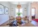 Elegant dining room with a round wooden table, stylish chairs, and a decorative chandelier at 1174 Hitchfield Ln, Awendaw, SC 29429