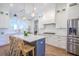 Bright kitchen featuring an island with seating, stainless steel appliances, and white cabinets at 1174 Hitchfield Ln, Awendaw, SC 29429