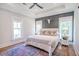 Spacious bedroom featuring a ceiling fan, wood accent wall, and three windows at 1174 Hitchfield Ln, Awendaw, SC 29429