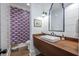 Chic powder room with vibrant purple wallpaper, wood countertop, vessel sink, and stylish mirror at 1174 Hitchfield Ln, Awendaw, SC 29429