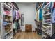 Spacious walk-in closet with custom shelving, hanging rods, and a central chest of drawers for ample storage at 1174 Hitchfield Ln, Awendaw, SC 29429