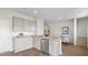 Bright kitchen with stainless steel appliances, granite countertops, light cabinets, and a view of the dining area at 127 River Hill Rd, Goose Creek, SC 29445