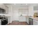 Well-lit kitchen showcasing stainless steel appliances, granite countertops, light cabinets, and wood flooring at 127 River Hill Rd, Goose Creek, SC 29445