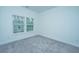 Empty bedroom with neutral carpet, light walls, and a window offering outside views at 1303 Twin Rivers Dr, Wando, SC 29492