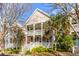 Attractive two-story home featuring double porches, complemented by mature trees and landscaping, creating a serene curb appeal at 1331 Appling Dr, Mount Pleasant, SC 29464