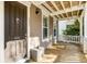 Inviting front porch features wood decking and beadboard ceiling, offering a cozy outdoor space with a view of the neighborhood at 1331 Appling Dr, Mount Pleasant, SC 29464