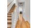 Hallway with staircase with carpet and hardwood floors leads to a room with a fireplace, seamlessly blending comfort and style at 1331 Appling Dr, Mount Pleasant, SC 29464