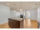 Open-concept living room with hardwood floors, a fireplace, and bright light provides a warm and inviting atmosphere at 1331 Appling Dr, Mount Pleasant, SC 29464