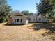 Spacious backyard featuring a well-maintained lawn, mature trees, and a view of the home's rear facade at 1344 Pickett St, Charleston, SC 29412