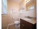 Cozy half bathroom offering a granite vanity, updated fixtures, and a framed mirror at 1344 Pickett St, Charleston, SC 29412