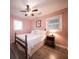 Cozy bedroom showcasing wood floors, soft pink walls, and natural light from a window at 1344 Pickett St, Charleston, SC 29412