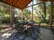 Inviting screened porch set up with outdoor dining table and chairs; perfect for enjoying meals outdoors at 1344 Pickett St, Charleston, SC 29412
