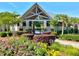 Community clubhouse surrounded by lush landscaping and colorful flowers and a peaked roof at 1399 Tollison Path, Mount Pleasant, SC 29466