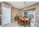 Cozy dining area with natural light, wood table, and view of the screened patio at 140 Satur Dr, Goose Creek, SC 29445