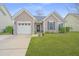 Charming single Gathering home featuring a manicured lawn and a one-car garage at 140 Satur Dr, Goose Creek, SC 29445