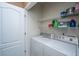 A practical laundry area featuring a side-by-side washer and dryer, complemented by overhead shelving at 140 Satur Dr, Goose Creek, SC 29445