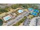 Wide aerial view of a community featuring pools, tennis courts, and playgrounds surrounded by green spaces at 1458 Clarendon Way, Mount Pleasant, SC 29466