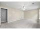 Spacious bedroom with neutral carpet, ceiling fan, and an open doorway at 1458 Clarendon Way, Mount Pleasant, SC 29466