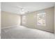 Neutral bedroom with two windows, a ceiling fan, and neutral walls and carpet at 1458 Clarendon Way, Mount Pleasant, SC 29466