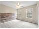 Cozy bedroom with plank accent wall, two windows, and neutral colored carpet at 1458 Clarendon Way, Mount Pleasant, SC 29466