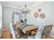 Elegant dining room featuring a wooden table, floral chairs, and a decorative chandelier, perfect for Gathering gatherings at 1458 Clarendon Way, Mount Pleasant, SC 29466