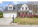 Charming two-story home featuring a well-manicured front yard and a welcoming front porch at 1458 Clarendon Way, Mount Pleasant, SC 29466