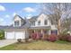 Traditional home with a two-car garage, dormer windows, and colorful landscaping at 1458 Clarendon Way, Mount Pleasant, SC 29466