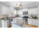 Bright kitchen featuring white cabinets, stainless steel appliances, and a center island at 1458 Clarendon Way, Mount Pleasant, SC 29466